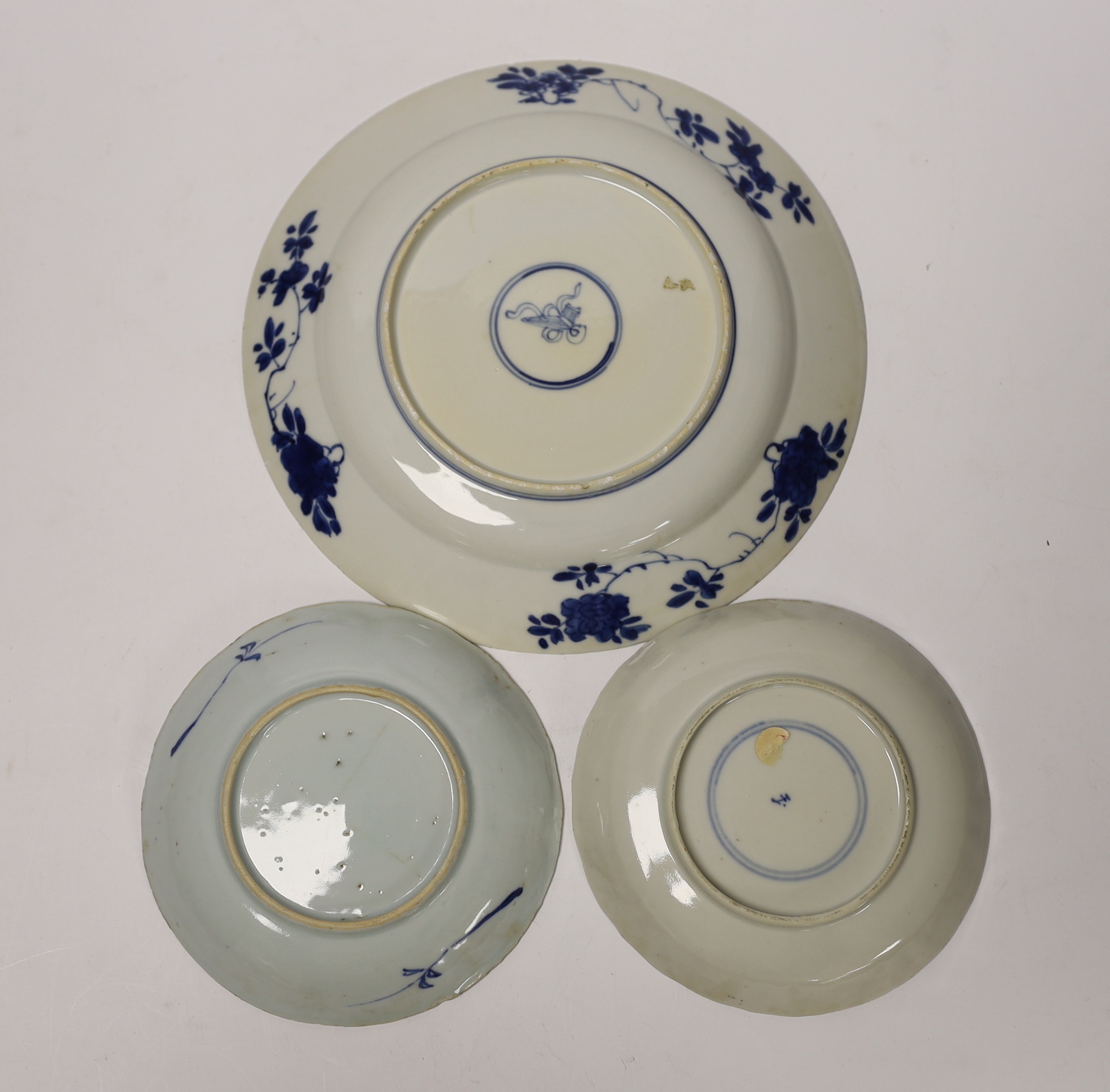 A Chinese Kangxi blue and white saucer dish and plate, and a similar 19th century blue and white saucer dish, largest 21cm in diameter